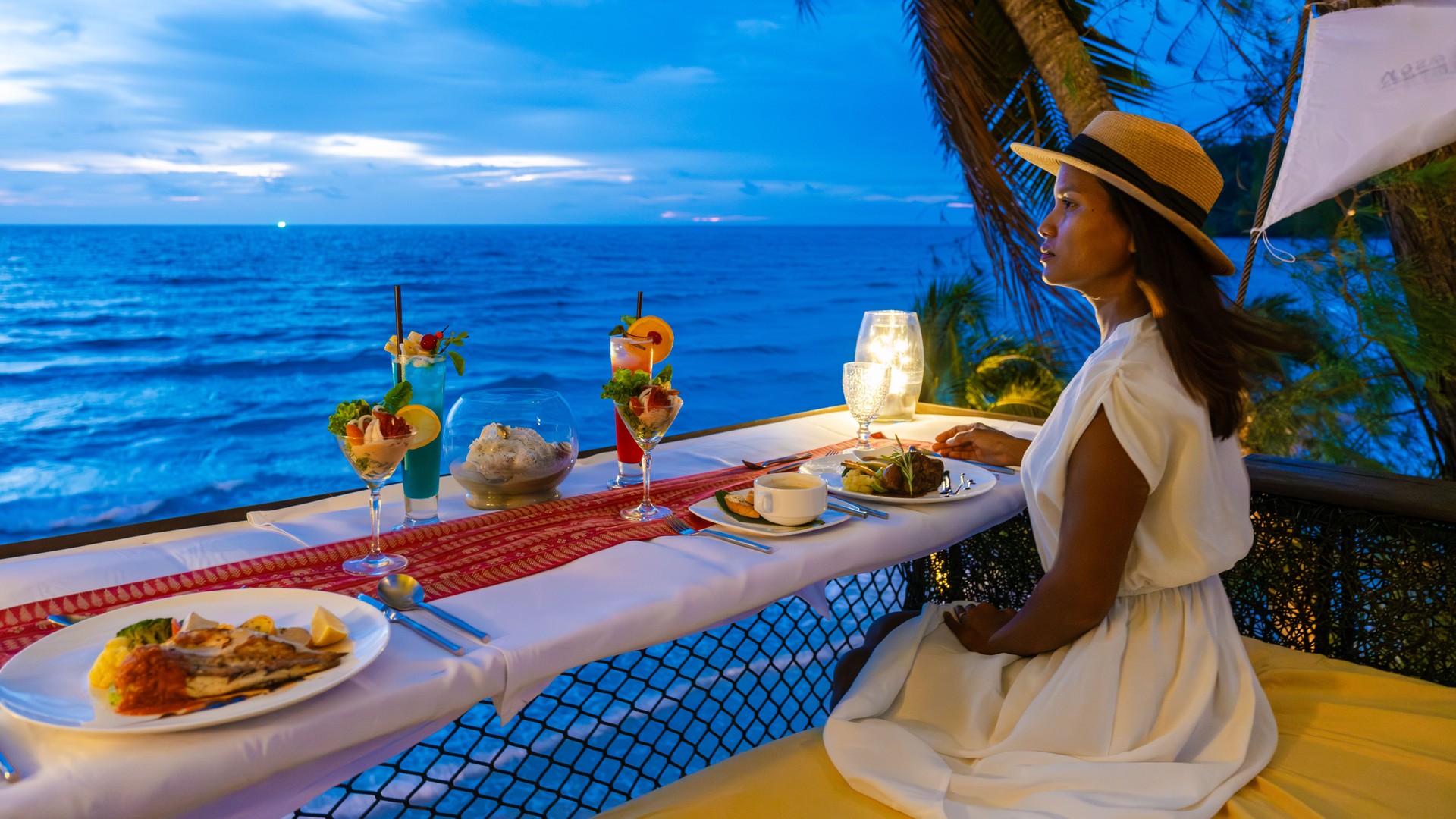 Romantic dinner on the beach in Koh Kood Thailand, couple having dinner on the beach during vacation